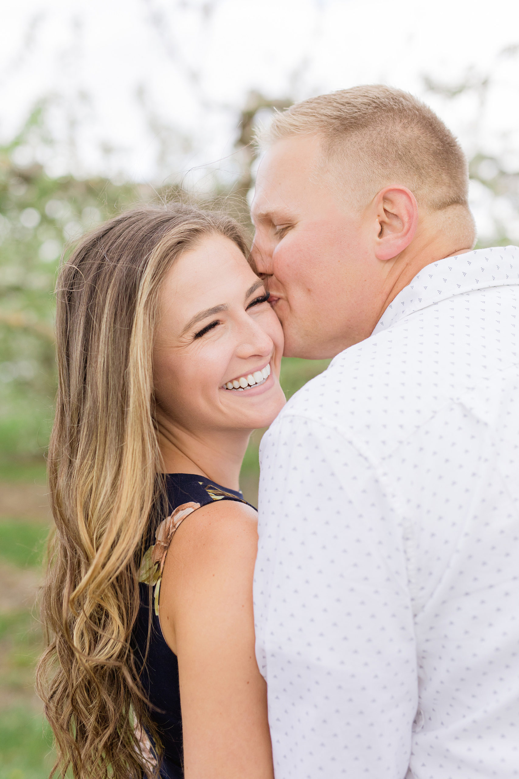 A classic Michigan Spring apple blossom engagement session at Blake’s Orchard by Breanne Rochelle Photography.
