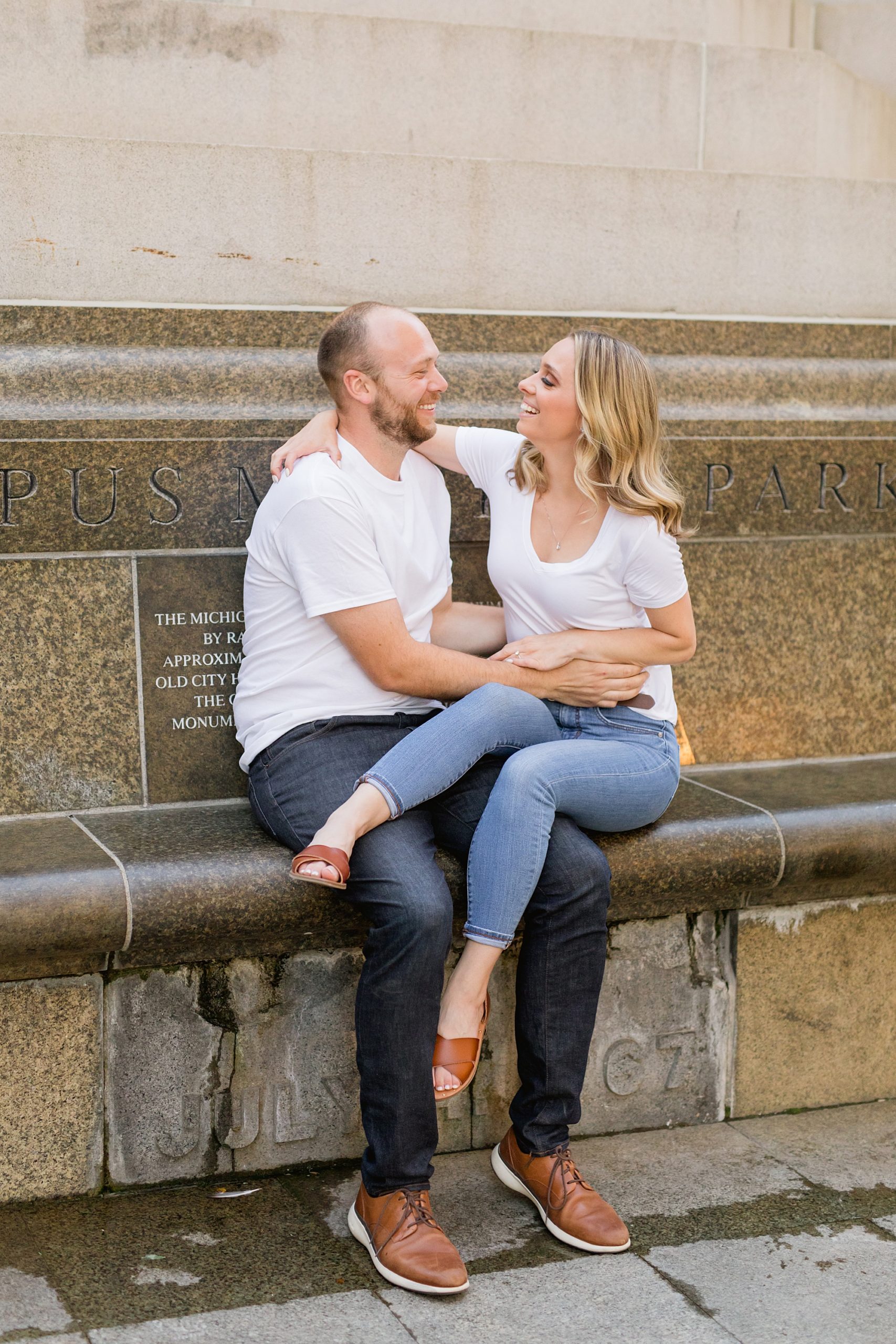 couple laughing and playing during engagement photo shoot