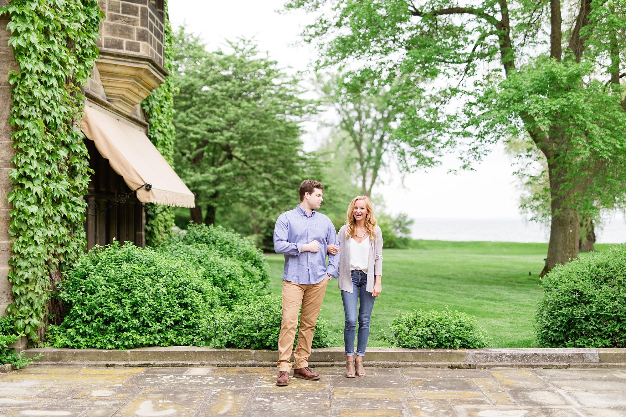 A classic spring engagement session filled with beautiful greenery and white blooms at the Edsel and Eleanor Ford House in Grosse Pointe, Michigan by Breanne Rochelle Photography.