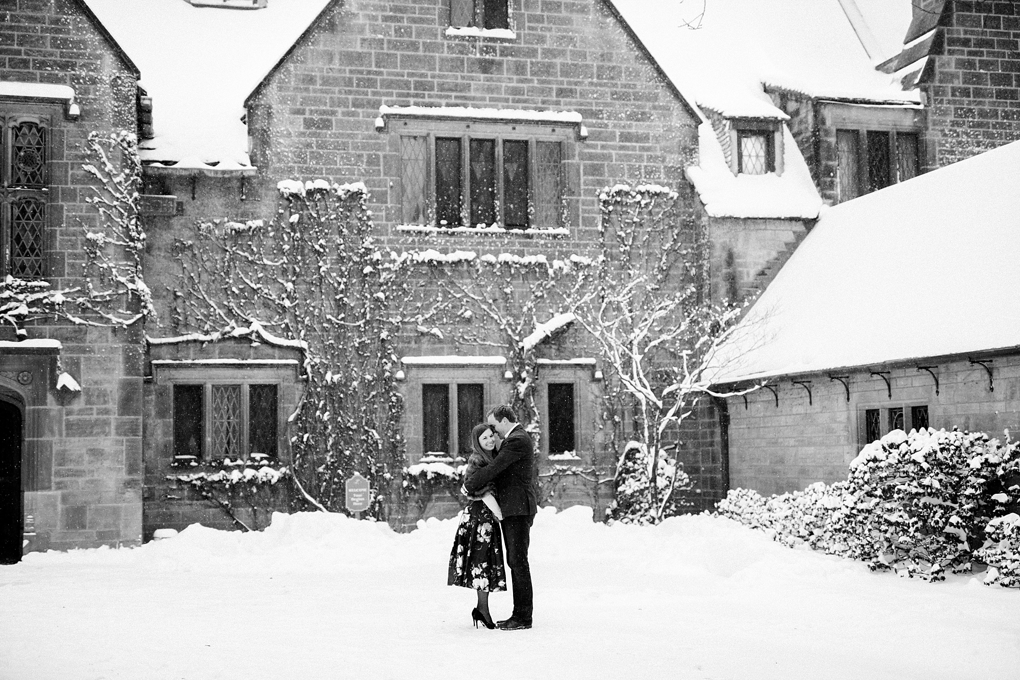 A winter engagement session filled with champagne and snowflakes at the Edsel and Eleanor Ford House in Grosse Pointe, Michigan by Breanne Rochelle Photography.