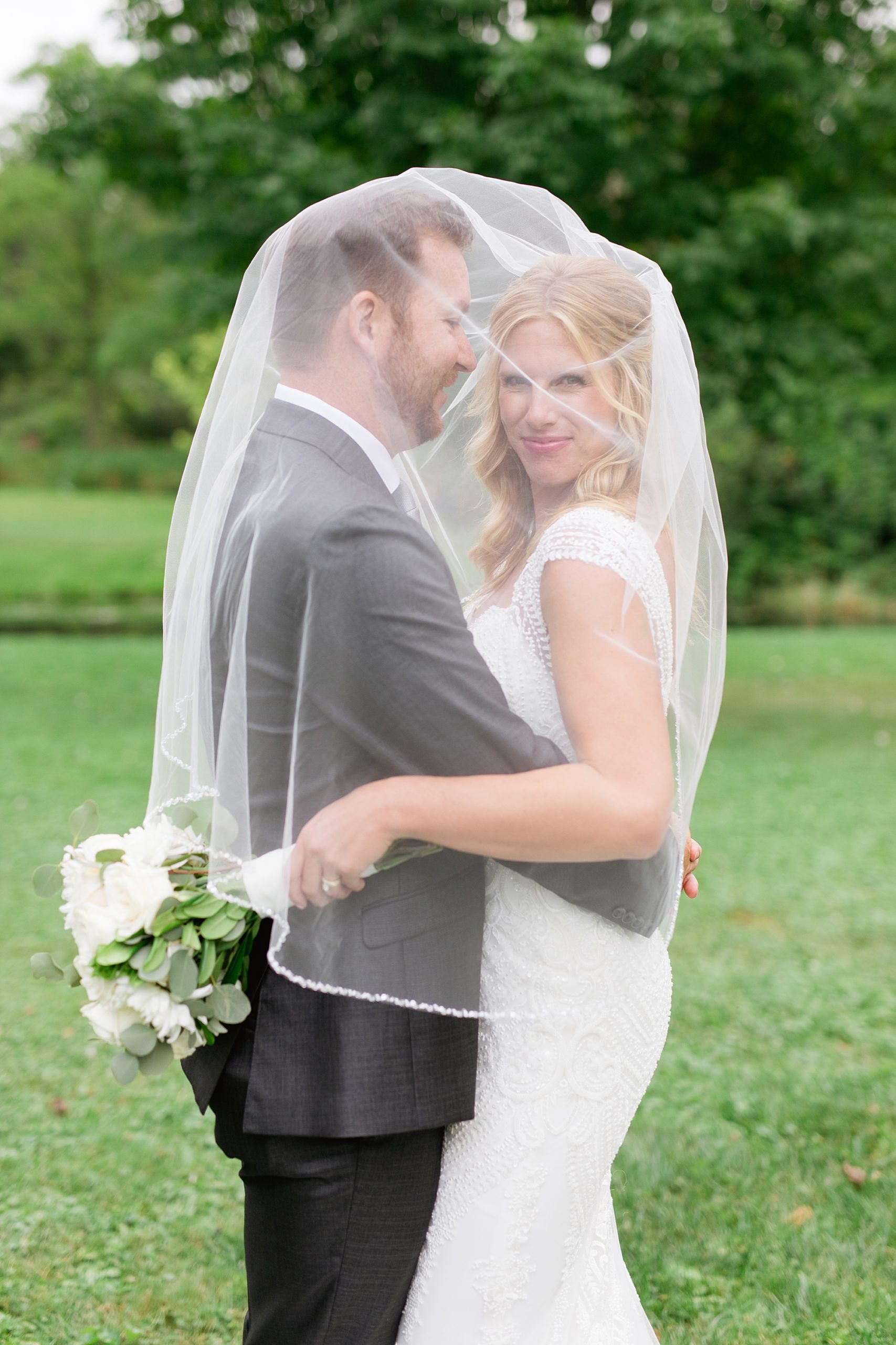 Bride and groom veil shot from outdoor tented wedding by Breanne Rochelle Photography.